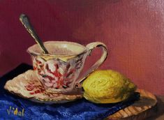 a painting of a tea cup and lemon on a blue cloth with a wooden tray