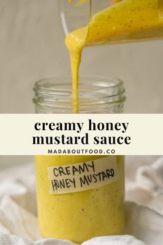 creamy honey mustard sauce in a mason jar with a spoon pouring it into the jar