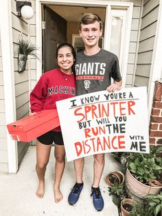 two people holding up a sign that says i know you're a sprinter but will you run the distance with me