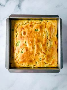 a square casserole in a metal pan on a marble counter