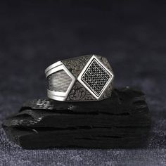 Our ring is designed in the form of small squares and embellished with black zirconia stones, it is 925 sterling silver. Zircon Black Stone Silver Square Men's Ring, Adjustable Ring, Handmade Jewelry, Unique Gift, Designer Ring, Gift for Him * Handmade product * Shipments from a small business in Turkey Turkey * Materials: Silver(925) * Adjustable * Customizable * Made to order Definition PRODUCT DETAILS * Made to order * Certified 925 sterling silver * Your ring comes in a beautiful ring box. R Gift Black Diamond Sterling Silver Ring, Sterling Silver Rings With Black Diamonds For Gift, Sterling Silver Ring With Black Diamonds For Gift, Luxury Diamond-shaped Silver Rings, Luxury Silver Diamond-shaped Rings, Luxury Black Spinel Silver Rings, Silver Sterling Silver Ring With Black Diamonds, Luxury Silver Rings With Black Spinel, Silver Sterling Silver Diamond Ring With Black Diamonds