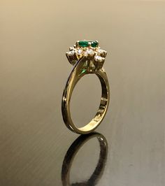 DeKara Designs Classic Handmade Art Deco Oval Emerald and Diamond Ring. This ring was entirely handmade by my father in the 1980's, anyone lucky enough to buy this ring will truly appreciate the workmanship and the beauty of this piece of art. Metal- 14K Yellow Gold, .583 Stones- 1 Oval Natural Green Emerald 0.45 Carats, 10 Round Diamonds, G-H color VS1 Clarity, 0.50 Carats. This ring is entirely put together piece by piece, and all the stones are carefully and expertly prong set. The ring is a Heirloom Gold Emerald Ring With Halo Detail, Heirloom Gold Emerald Ring With Halo, Heirloom Gold Marquise Cut Emerald Ring, Heirloom Marquise Cut Gold Emerald Ring, Vintage Emerald Ring With Brilliant Cut For Wedding, Vintage Style Emerald Cluster Ring In Yellow Gold, Vintage Brilliant Cut Emerald Wedding Ring, Vintage Round Halo Diamond Ring, Vintage Round Diamond Ring With Halo