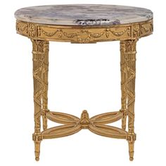 an ornately decorated table with marble top