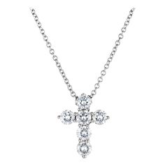 .90ct 6 round brilliant cut diamond cross pendant necklace, set in 18k white gold with a 16 inch 18k white gold chain. 6 round brilliant cut diamonds G-H, SI approx. .90cts 18k white gold Stamped: 18k 3.4 grams Top to bottom: 15.5mm or 5/8 Inches Width: 12.1mm or .5 Inches Depth or thickness: 3.6mm Chain: 16 Inches Width: 1.3mm Thickness/Depth: 1.3mm White Gold Chain, White Gold Chains, Diamond Cross Pendants, Diamond Cross, Cross Pendant Necklace, Round Brilliant Cut Diamond, Brilliant Cut Diamond, Cross Pendant, Round Brilliant