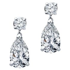 These petite diamond earrings feature 2.35 carat total weight in pear shaped diamonds that dangle from 0.30 carat total weight in round diamonds. They are set in 14 karat white gold with friction post and back. These are delicate to wear everyday but can also shine in the evening! Pear Shaped Diamonds: SI1-SI2, K Formal Teardrop Single Cut Diamond Earrings, Formal Pear-shaped Diamond Earrings With Single Cut Diamonds, Classic Pear-shaped Diamond Earrings With Single Cut, Teardrop Diamond Earrings With Vvs Clarity For Formal Events, Pear-shaped Brilliant Cut Diamond Earrings, Classic Diamond Teardrop Earrings, Fine Jewelry Teardrop Earrings With Brilliant Cut, Formal Pear-shaped Teardrop Earrings With Diamond Cut, Luxury Diamond White Diamond Teardrop Earrings