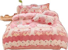 a pink and white comforter set with hello kitty pillows on top of the bed