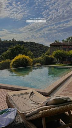 an empty swimming pool surrounded by trees and bushes