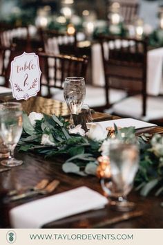 the table is set with place cards and silverware