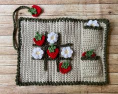 a crocheted placemat with strawberries and flowers on it