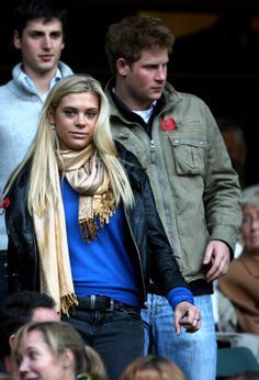 a man and woman standing next to each other in front of a group of people