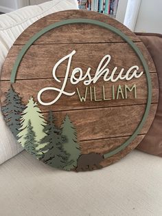 a wooden sign that says joshua william with trees on the front and back of it