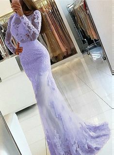 a woman taking a selfie in front of a mirror wearing a long purple dress