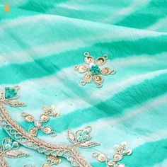 Experience the Enchantment: Elevate your style with our mesmerizing Green Leheriya Saree, a splendid fusion of tradition and opulence. This exquisite creation showcases the timeless allure of Zardozi and Aari Work, complemented by a charming scalloped border, making it a radiant addition to your wardrobe. A Timeless Addition: Ideal for weddings, special occasions, or festive celebrations, this Green Leheriya Saree with Zardozi and Aari Work is a symbol of timeless elegance and tradition. It capt Leheriya Saree, Scalloped Border, Border Saree, The Enchantments, Aari Work, Timeless Elegance, Special Occasion, Essence, Saree