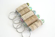 four wine corks are sitting in a row on a white surface with metal handles