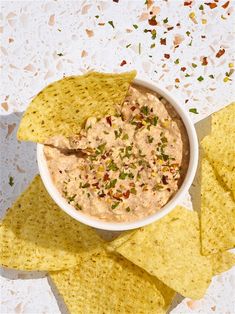 tortilla chips and dip in a white bowl