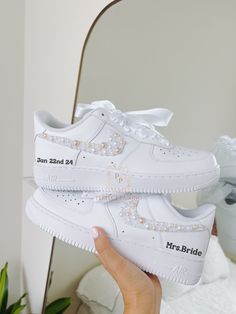 -This is a custom Bridal sneaker.  -Option 1 is only Name and date -Option 2 has pearls on the outer 2 swooshes and names and dates. -Offers more designs and colors of pearls/check out my store/ -Open for custom requests. TURNAROUND TIME: -2 weeks to be crafted just for you -Shipping will take an additional 3-7 business days. -We offer FREE shipping within the US. -EXPEDITED service available Visit the link below for EXPEDITED SERVICE: https://perfctpairings.etsy.com/listing/1537883783 for PURCH Shoes For Wedding Reception, Bride Nike Air Force, Bride Reception Shoes, Shoes For Wedding The Bride, Bride Tennis Shoes, Nike Wedding Shoes, Wedding Reception Shoes, Engagement Shoes, Sneakers For Bride