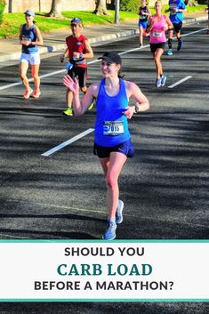 a woman running in a marathon with the words should you carb load before a marathon?