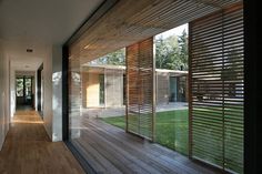 an outdoor area with wooden slats and sliding glass doors on the side of it