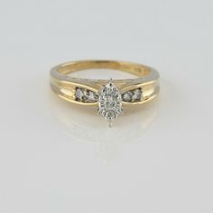 10K Yellow Gold Diamond Illusion Ring, 7 round diamonds total, 3 in a marquis shape, Illusion setting in center, I love you engraved into sides, Ring size 8, Circa 1990, 4.13 grams SKU# BB280R12 This listing contains photographs of the actual item you will receive. Our items are in excellent condition with little or no signs of wear and many are one of a kind pre-owned estate finds. Please look closely at the pictures in this listing as they are part of the product description. Please read the d Classic Marquise Cluster Ring For Anniversary, Marquise Diamond Ring With Vs Clarity For Anniversary, Marquise Diamond Ring With Accents For Anniversary, Classic Marquise 14k Stamped Diamond Ring, Classic Marquise Cluster Ring Stamped 14k, Classic Marquise Diamond Ring Stamped 14k, Classic 14k Marquise Diamond Ring, Classic Marquise Diamond Ring, Heirloom Marquise-cut Diamond Ring For Anniversary