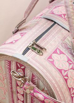 Incredibly spacious and lightweight, this handcrafted bag is perfect for a weekend getaway. Take it on the plane as your TSA-approved carry-on and turn heacs. This Dewi weekender bag features stunning, intricate embroidery and is 100% cruelty-free, making it the best-looking vegan bag for the conscious consumer on the market.﻿﻿Snap button closure on the exterior front. Details: ﻿﻿Three pockets including one zippered in the cotton-lined interior ﻿﻿Comfortable, detachable and adjustable body strap Traditional Tote Weekender Bag For Travel, Luxury Embroidered Travel Bags, Traditional Rectangular Duffle Bag For Travel, Travel Bag With Top Carry Handle For Trips, Traditional Satchel For Travel, Traditional Rectangular Weekender Bag For Travel, Traditional Travel Bag With Top Carry Handle, Traditional Travel Shoulder Bag With Detachable Handle, Traditional Shoulder Bag With Detachable Handle For Travel