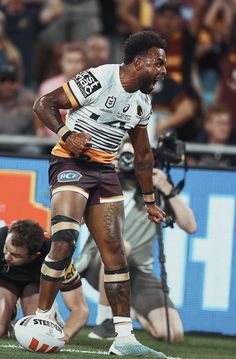 a rugby player is on the ground with his ball