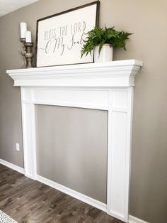 a white fireplace mantel with a sign above it