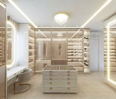 a large walk in closet with lots of drawers and lights on the ceiling above it