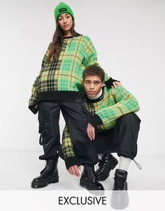 two people in matching outfits posing for the camera with one person leaning on his back