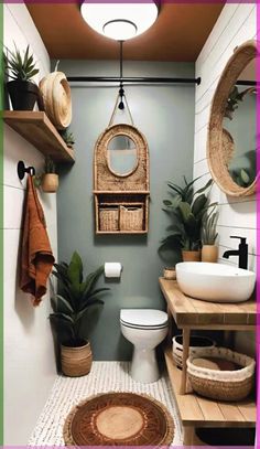 a bathroom that has some plants on the wall and a toilet in it with a mirror above