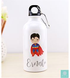 a water bottle with an image of a boy wearing a superman suit and name on it