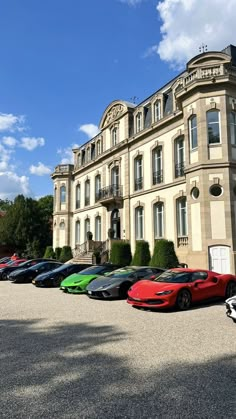 several cars parked in front of a large building