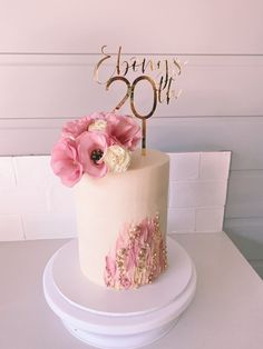 a birthday cake decorated with pink flowers and the number 50 on it's top