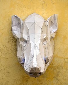 a paper cut animal head mounted to the side of a wall