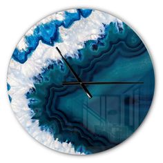 a clock with blue and white designs on it