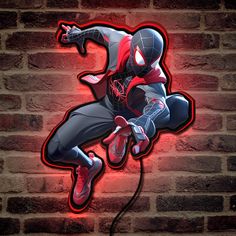 a spider man neon sign on a brick wall in the shape of a jumping person