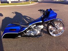 a blue motorcycle is parked on the street