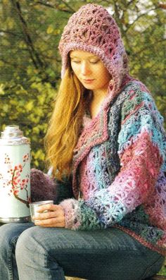 a woman sitting on a bench holding a coffee cup