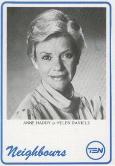 an old photo of a woman with short hair and blue lettering on the back of her card