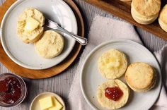 biscuits with butter and jam are on plates