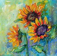 two yellow sunflowers in a blue vase