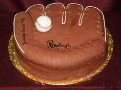 a cake shaped like a baseball glove with a ball on top