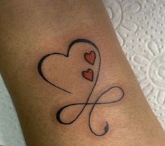 a woman's arm with two hearts in the shape of a heart on it