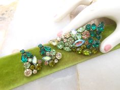 Crystal rhinestone demi parure. Love the ombre green design. Aurora borealis accent. Brooch earrings set. Designer - Austria All prong set stones. Triangle brooch 2.5"  by  1.25" Clip on earrings. -Length 1" Good vintage condition. MORE jewelry sets here: https://www.etsy.com/shop/VivianJoel?ref=seller-platform-mcnav&section_id=26068749 MORE everything VivianJoel here: https://www.etsy.com/shop/vivianjoel Desired cleaning is left to new owner.   Still uncertain about size?   Compare to pieces yo Green Crystal Brooch Jewelry, Ombre Green, Mid Century Jewelry, Green Ombre, Wedding Jewelry Earrings, Crown Jewels, Green Design, Aurora Borealis, Wedding Earrings