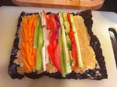 a cutting board topped with sliced up veggies on top of rice krispy treats