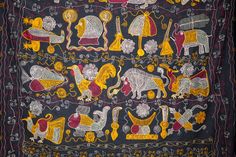 an embroidered cloth with animals and people on it