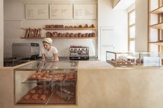 a baker is working behind the counter in a bakery