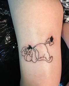 a woman's arm with a small dog tattoo on it