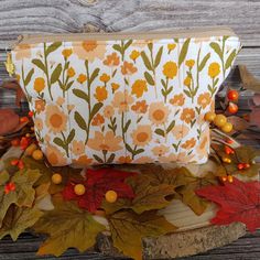 "A floral quilted makeup bag with a lovely leaf design lining and a maple leaf charm attached to the zip pull. This makeup bag is handy size to fit in your handbag or take away with you on your travels. Great for your perfumes and lotions, jewellery, chargers and cables and of course your makeup. A great gift for someone who loves anything Autumnal and flowers. Or just treat yourself. Size : approx  8\" x 6\"  The bag is interfaced with a soft fleece and quilted. From a smoke free home. UK : I will post Royal Mail 48 hr tracked no signature. USA : I will post Royal Mail International tracked no signature. Buyer is responsible for any custom charges. I can normally post next working day. I do accept returns but please contact me first to see if we can resolve any issues." Retro Bags With Zipper Pouch As Gift, Vintage Orange Bag As Gift, Retro Bags With Zipper Pouch For Gifts, Retro Gift Bag With Zipper Pouch, Orange Zipper Pouch Bag For Gift, Floral Makeup Bag, Vintage Orange Bag For Gift, Orange Zipper Pouch Gift, Gift Orange Zipper Pouch