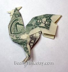 an origami bird made out of one dollar bill