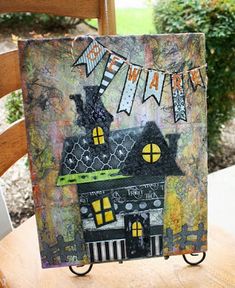 a card with a house on it and the words happy halloween written in front of it